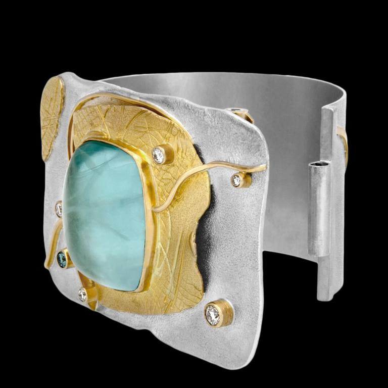 Custom sterling silver and 18kt yellow gold cuff with a cabochon-cut aquamarine and diamonds. Shackle cuff. Open | Shield™ Collection. FRIDA | Fine Jewellery