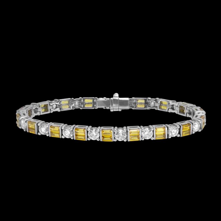 Custom 18kt white gold tennis bracelet with yellow sapphire baguettes and brilliant-cut diamonds. Front. FRIDA | Fine Jewellery.