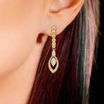 Custom 18kt yellow gold huggie earringswith pear and marquise diamond drop. Perspective. FRIDA | Fine Jewellery.