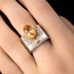 Custom 18kt white and pink gold statement ring with an oval peach sapphire and diamonds. Perspective. FRIDA | Fine Jewellery.