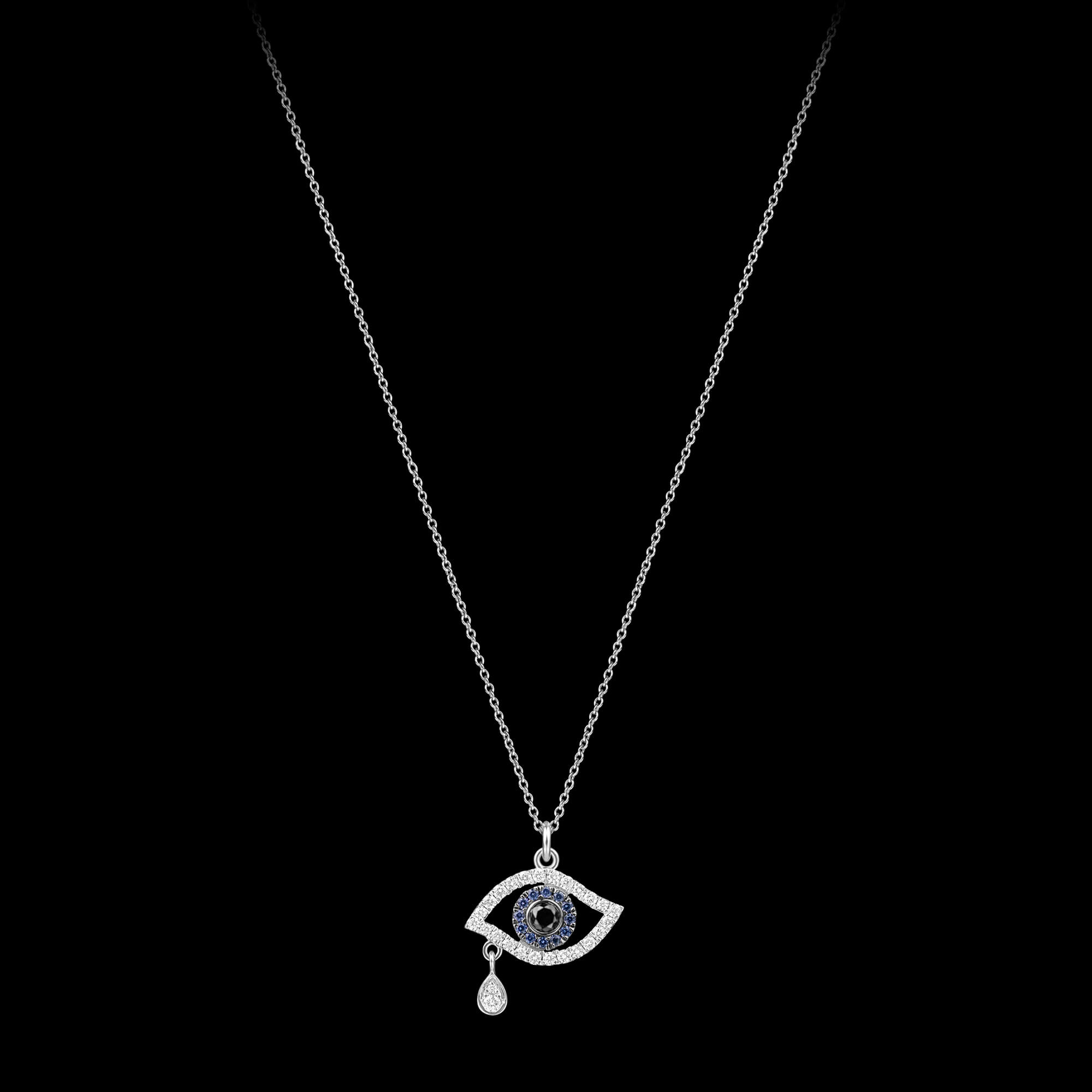 Custom 18kt white gold evil eye necklace set with diamonds and blue sapphires. FRIDA | Fine Jewellery.