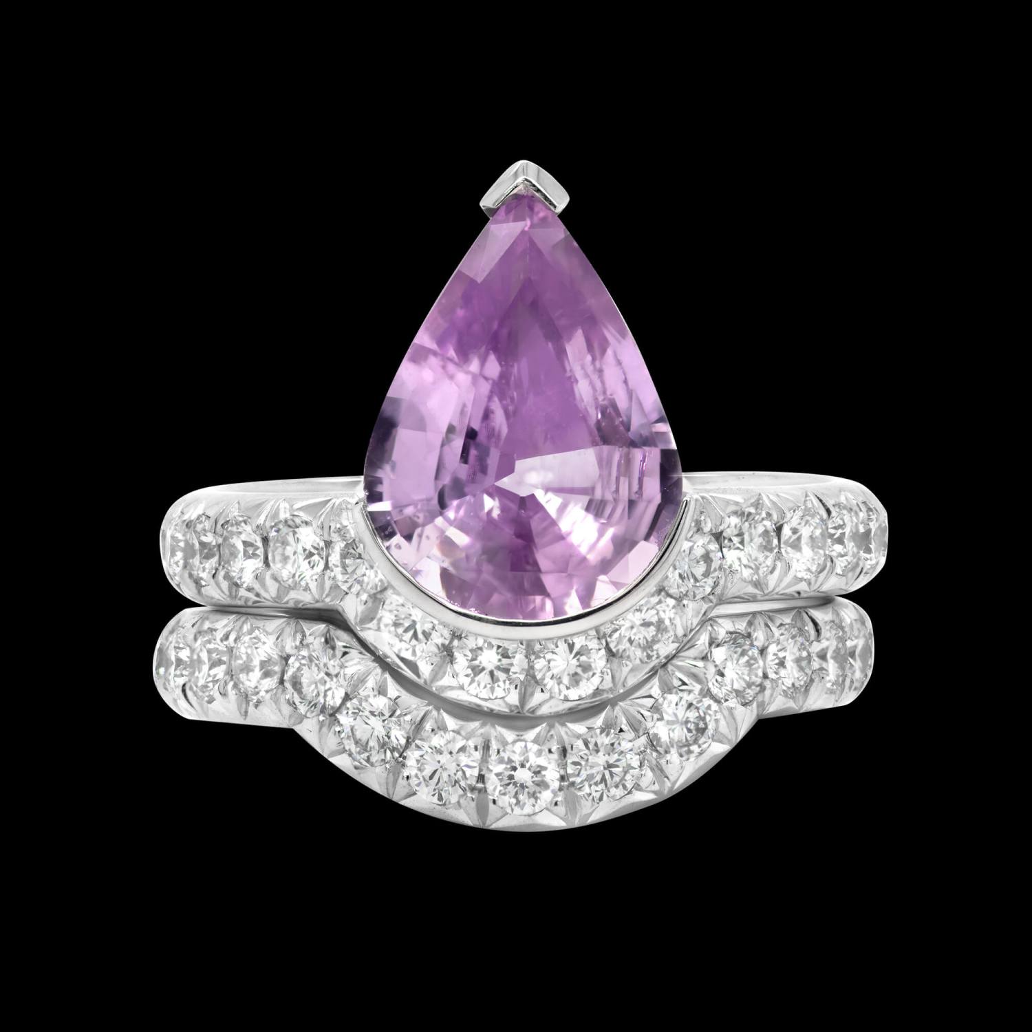 Custom engagement ring in 18kt white gold with a natural pear pink-lavender sapphire and diamonds with interlocking band. Front | Signature Engagement. FRIDA | Fine Jewellery.