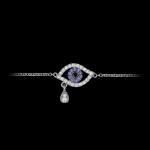 Custom 18kt white gold evil eye bracelet set with diamonds and blue sapphires. View 1. FRIDA | Fine Jewellery.