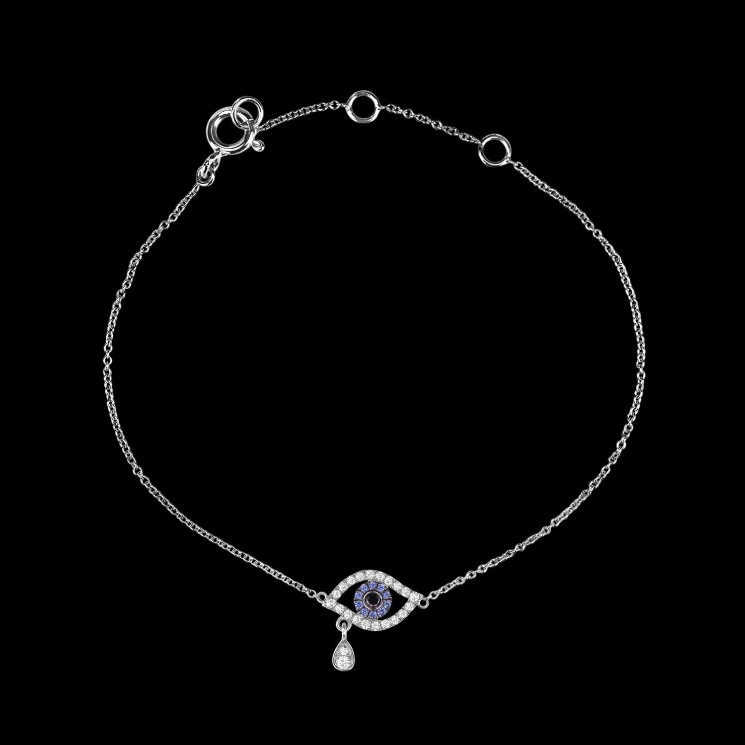 Custom 18kt white gold evil eye bracelet set with diamonds and blue sapphires. View 2. FRIDA | Fine Jewellery.