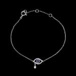 Custom 18kt white gold evil eye bracelet set with diamonds and blue sapphires. View 2. FRIDA | Fine Jewellery.