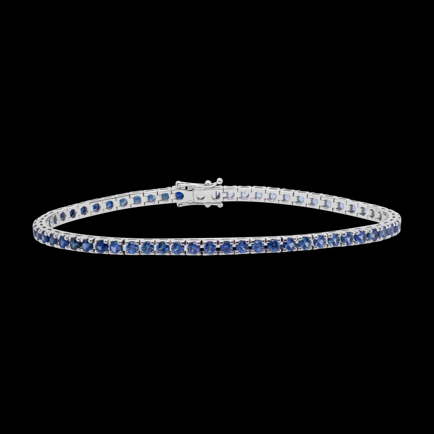 Custom 18kt white gold men's tennis bracelet with an ombre of blue sapphires. Front. FRIDA | Fine Jewellery.