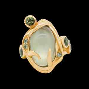 One-of-a-kind 18kt yellow gold statement Èze ring with a moonstone and green sapphires. Front | Shield Collection. FRIDA | Fine Jewellery.