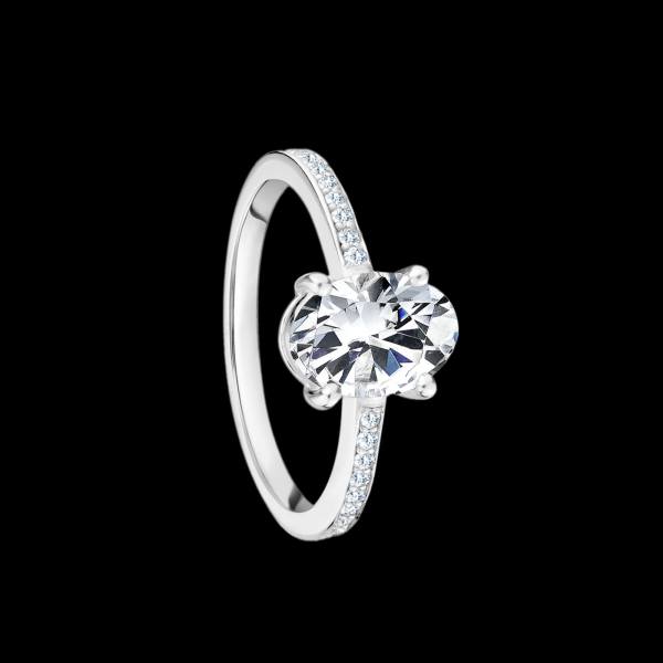 Custom 18kt white gold solitaire with diamonds with prong set oval diamond and diamond shank. FRIDA | Fine Jewellery.