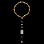 Custom 18kt yellow gold pendant with Karur aquamarine, sapphires, South Sea pearls and brilliant-cut diamonds on golden South Sea pearls. FRIDA | Fine Jewellery.